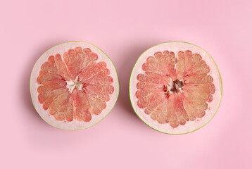 Fresh cut pomelo fruit on pink background, flat lay