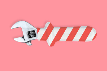 Adjustable metal wrench. Background made of a metal adjustable wrench with a rubber striped handle. 