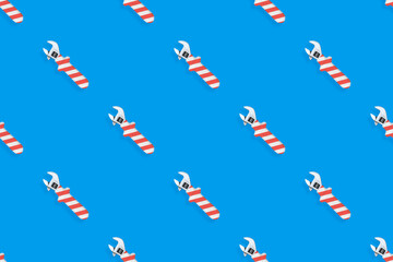 Adjustable wrench seamless pattern. Background made of a metal adjustable wrench with a rubber striped handle. 