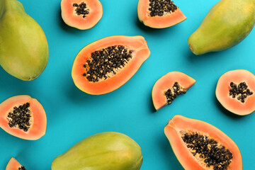 Fresh ripe papaya fruits on blue background, flat lay