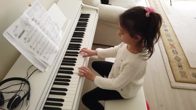 little pianist. the Pretty Girl is at home taking piano lessons. tiny fingers and musical notes