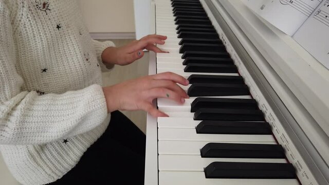 little pianist. the Pretty Girl is at home taking piano lessons. tiny fingers and musical notes