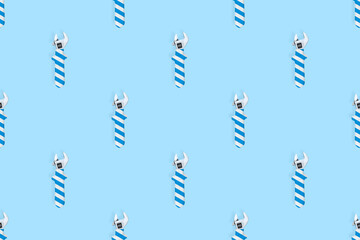 Adjustable wrench seamless pattern. Background made of a metal adjustable wrench with a rubber striped handle. 