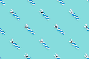 Adjustable wrench seamless pattern. Background made of a metal adjustable wrench with a rubber striped handle. 