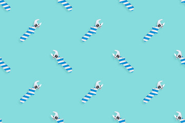 Adjustable wrench seamless pattern. Background made of a metal adjustable wrench with a rubber striped handle. 