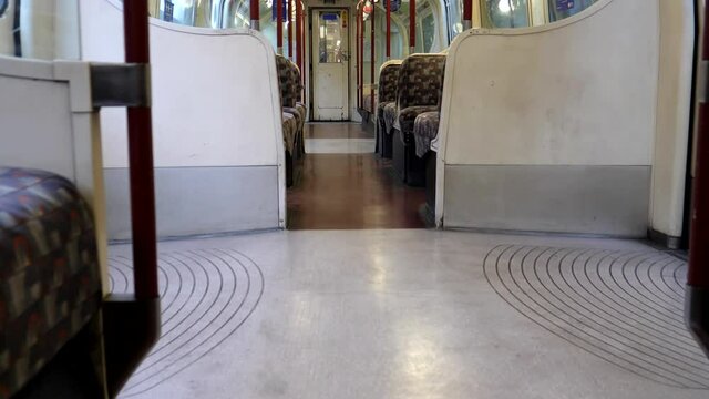 Travelling in an empty underground or subway carriage, handheld camera.