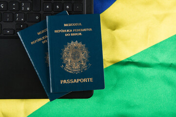 Brazilian passport with Brazilian flag in the background