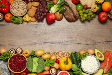 Different products on wooden table, top view with space for text. Healthy food and balanced diet