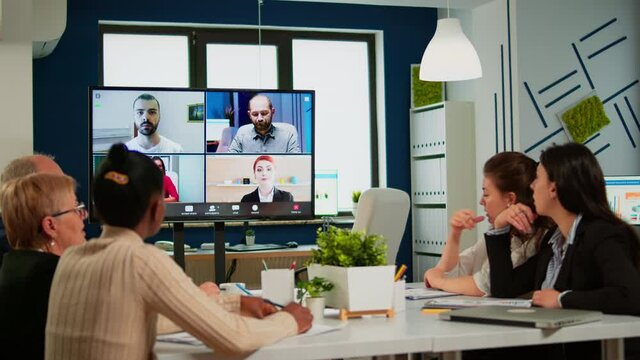 Emplyees workers having webcam group conference with coworkers speaking on video chat call with diverse colleagues online briefing. Diverse people talking at virtual meeting, online discussion.