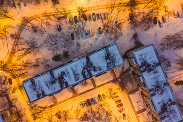 Winter evening aerial top down view to buildings roof in Kharkiv