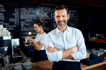 Fototapeta na wymiar Successful restaurant manager small business owner standing in cafe