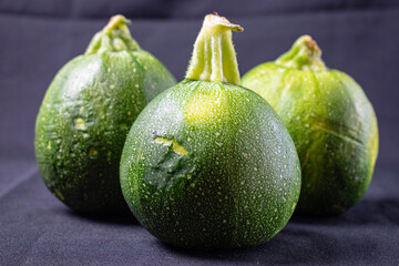 round italian squash on black background