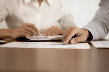 The businessman pointed to the company's marketing material  where the staff was writing