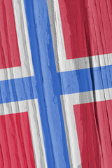 The flag of Norway on a dry wooden surface, cracked with age. Light pale faded paint. Patriotic background or wallpaper. Scandinavian cross. Annual rings of old wood. Vertical backdrop