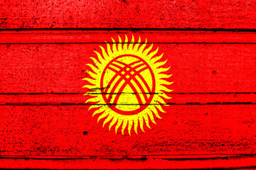 National flag of Kyrgyzstan, abbreviated with kg; a realistic 3d image of the national symbol from an independent country painted on a wooden wall