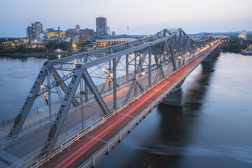 Fototapeta na wymiar Evening view from above of the landmark Alexandra Bridge which links two Canadian provinces Ottawa, Ontario to Hull, Quebec.