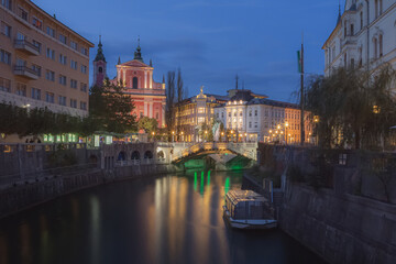Scenic evening view of the historic old town of Ljubljana, capital of Slovenia over the Ljubljanica River toward Triple Bridge (Tromostovje).