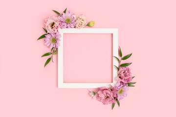 Square flower frame made of eustoma on a pink background. Greeting card template with copyspace. Tenderness concept.