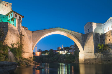 Fototapeta na wymiar Evening, blue hour view of the iconic Stari Most bridge, Neretva River and old town of Mostar, Bosnia and Herzegovina.