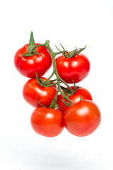 a brush of six large tomatoes on a white background. Studio photo, isolate, tomatoes, washed