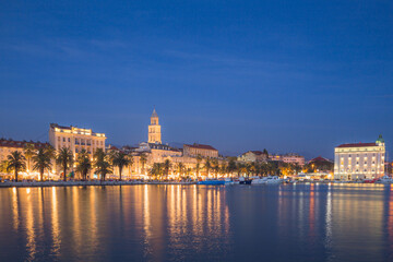 Obraz na płótnie Canvas An evening view of the city lights of the Split waterfront and promenade on the Adriatic coast of Croatia.