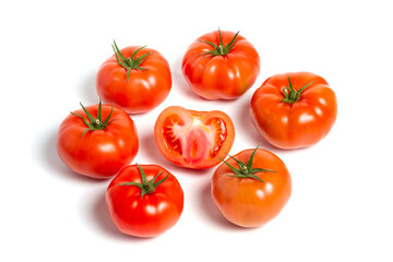 a group of tomatoes on a white background, with shadows. One tomato cut, studio photo, isolate, tomatoes washed
