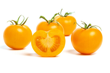 multiple yellow cherry tomatoes on a white background with shadow