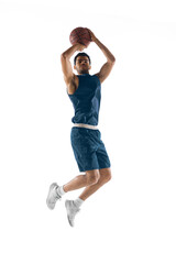 Slam dunk. Young arabian muscular basketball player in action, motion isolated on white background....