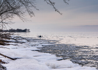 Kayaking through ice circles on a beautiful lake