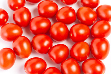 a few tomatoes on a white background with a shadow.