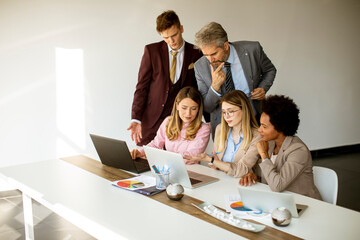 Multiethnic group of business people working together and preparing new project on a meeting in office