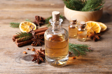 Anise essential oil and spices on wooden table