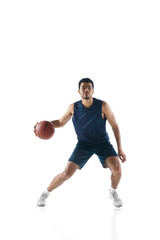 Plakat Competitive. Young arabian muscular basketball player in action, motion isolated on white background. Concept of sport, movement, energy and dynamic, healthy lifestyle. Training, practicing.