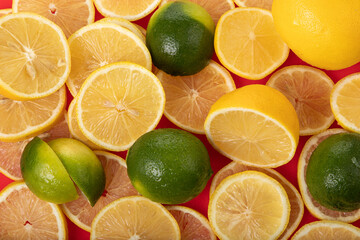Naklejka na ściany i meble fresh limes and lemons sliced on red chopping board