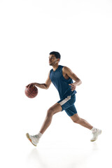 Naklejka na ściany i meble Competitive. Young arabian muscular basketball player in action, motion isolated on white background. Concept of sport, movement, energy and dynamic, healthy lifestyle. Training, practicing.