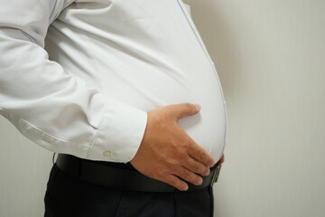 Overweight businessman body with hands touching belly fat - お腹の出ているビジネスマン - obrazy, fototapety, plakaty