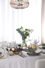 Beautiful Easter table setting with festive decor indoors