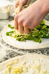 Pizaiolo Preparing Pizza in Restaurant with Fresh Ingredients. Chef at Work