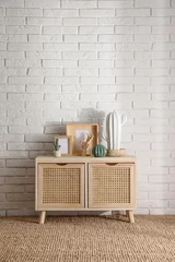 Fotobehang Boho Stylish room interior with wooden cabinet near white brick wall  © New Africa