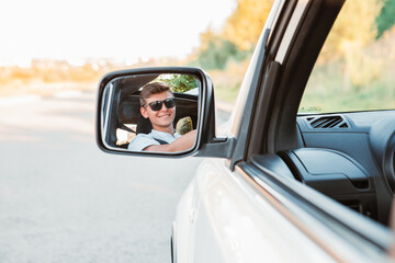 young handsome confident man driving car