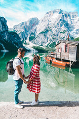Fototapeta na wymiar couple holding hands looking at mountain lake