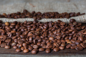 Background of coffee beans. Roasted coffee beans on a wooden table.