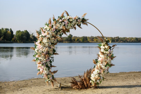 Circle Wedding Arch Decorated With White Flowers And Greenery Outdoors, Copy Space. Wedding Setting. Floral Composition