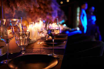 The served table in the luxury restaurant. Dark wooden table, beautiful evening restaurant with...