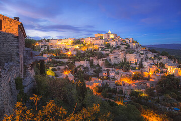 Fototapeta na wymiar A stunning summer's evening view of the beautiful and historic hilltop village of Gordes, in Provence France