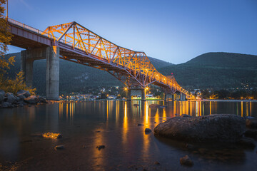 Night view of the iconic Big Orange Bridge in Nelson, B.C. on a summer's evening after sunset on Kootenay Lake.