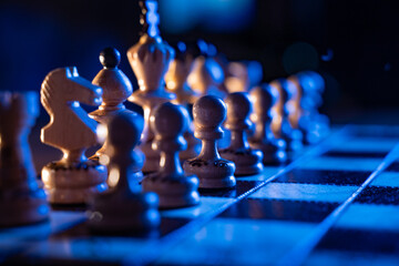 Chess board with chess pieces on blue background. Concept of business ideas and competition and...