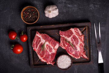 Barbecue Rib Eye Steak on wooden cutting board at kitchen table