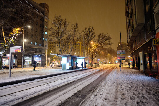 Street Of A City At Night On A Snowy Day.