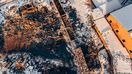 Aerial photography of scrap metal dump, Crane unloads, loads scrap metal in a railway car.